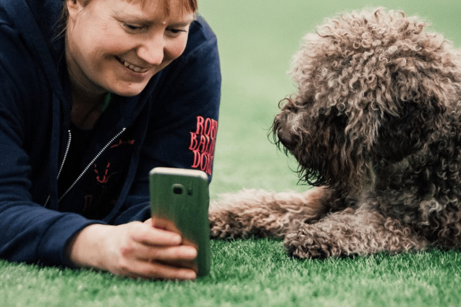 woman and dog watching video